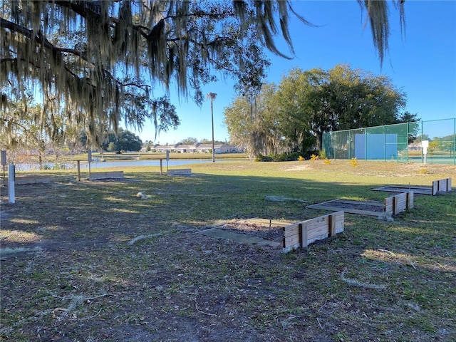 view of yard with a water view and fence