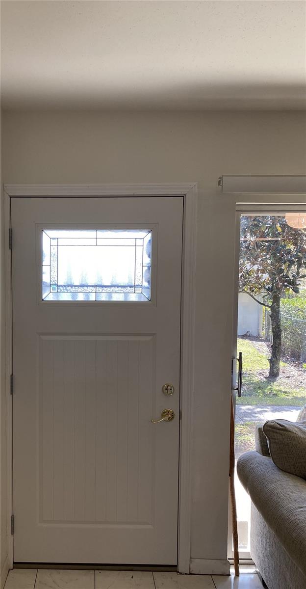 entryway featuring a wealth of natural light and light tile patterned floors