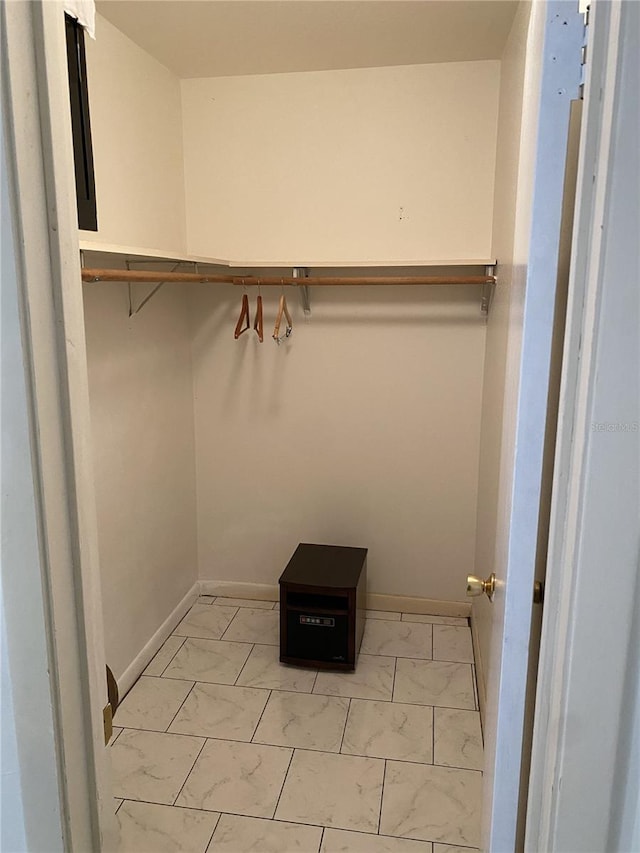 spacious closet with marble finish floor