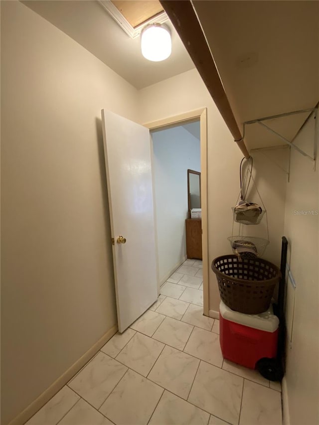 interior space featuring marble finish floor and baseboards