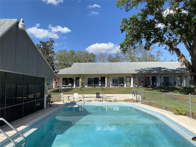 view of swimming pool with a fenced in pool, a yard, and fence