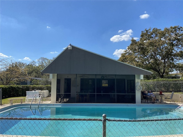 view of pool featuring a patio, fence, a sunroom, a ceiling fan, and a fenced in pool