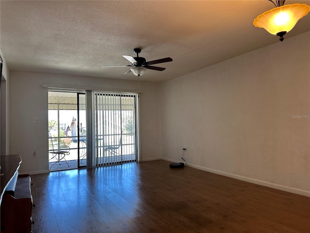 spare room with baseboards, wood finished floors, and a ceiling fan