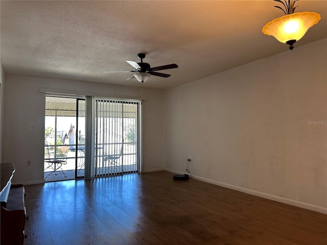 spare room with a ceiling fan, wood finished floors, baseboards, and a textured ceiling