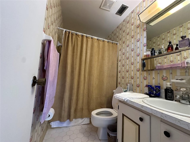 bathroom featuring visible vents, toilet, vanity, and wallpapered walls