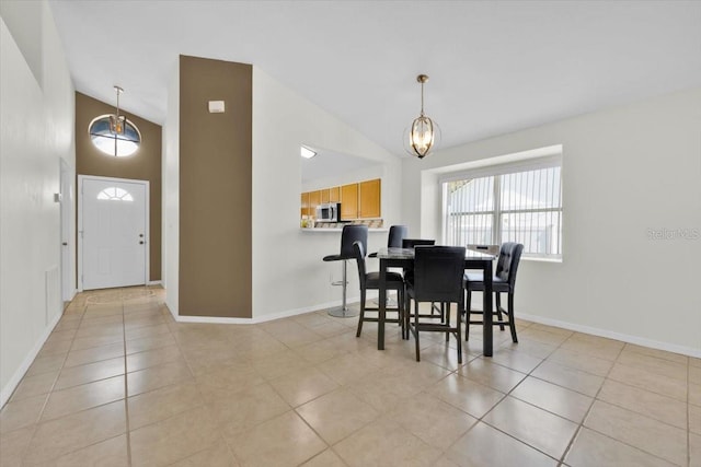 dining room featuring high vaulted ceiling, a notable chandelier, baseboards, and light tile patterned floors