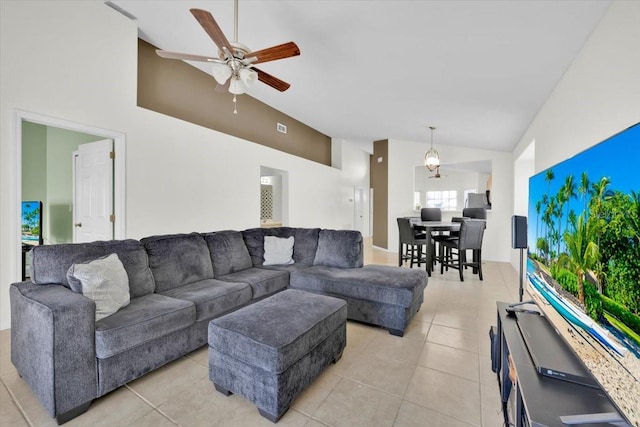 living room featuring light tile patterned floors, ceiling fan, visible vents, and high vaulted ceiling