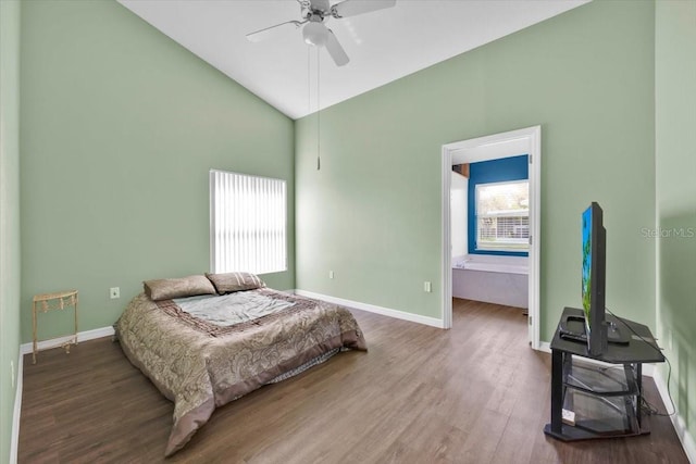 bedroom featuring lofted ceiling, ceiling fan, wood finished floors, and baseboards