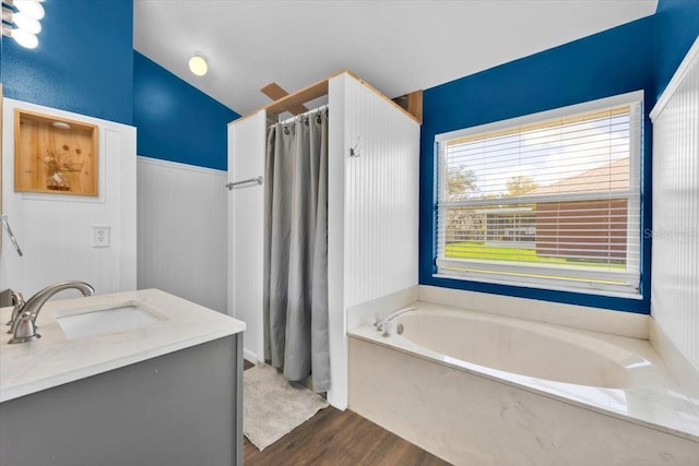 bathroom with lofted ceiling, curtained shower, a sink, wood finished floors, and a bath