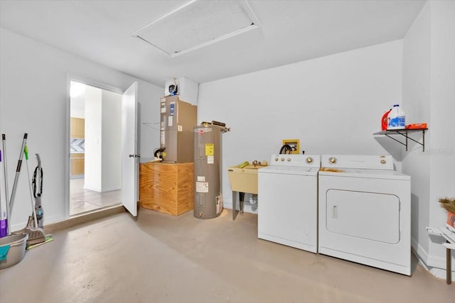 clothes washing area featuring laundry area, a sink, water heater, independent washer and dryer, and attic access