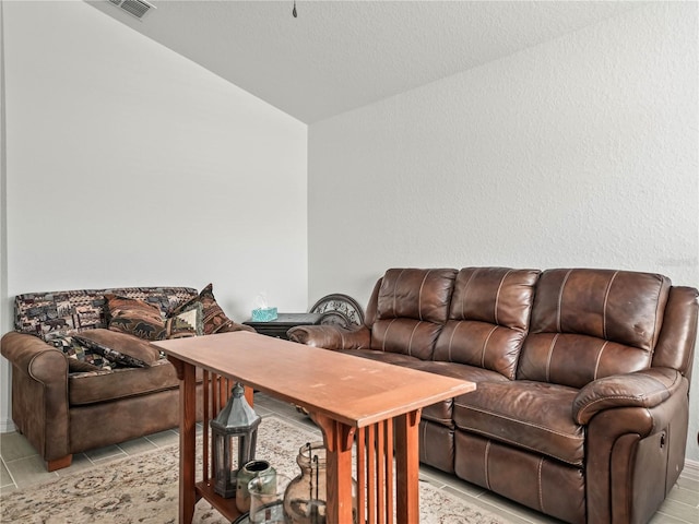 living room with light tile patterned floors and lofted ceiling