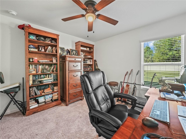 home office featuring light colored carpet and ceiling fan