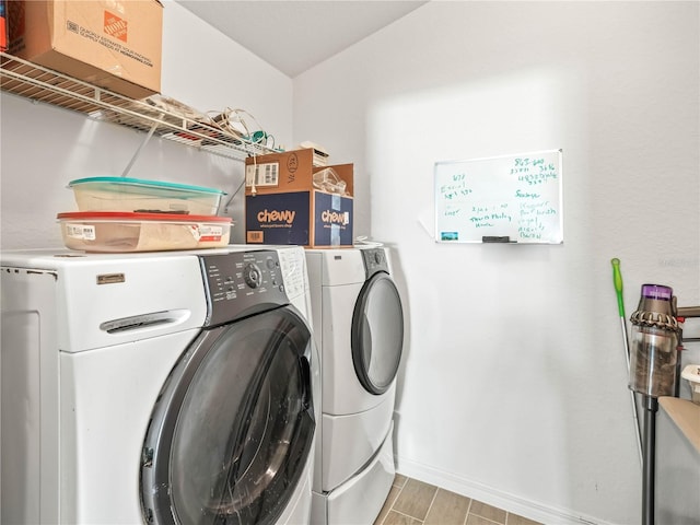 laundry area featuring baseboards, washing machine and dryer, and laundry area