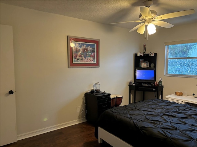 bedroom with dark wood-style flooring, baseboards, and ceiling fan