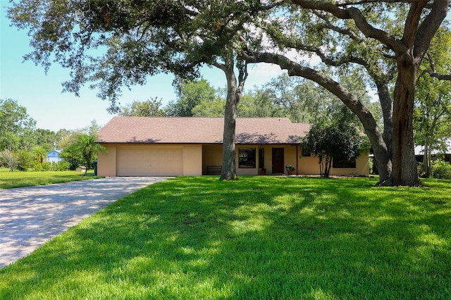 3567 Red Oak Ct, Lake Wales, FL 33898 - single story home with an attached garage, a front lawn, concrete driveway, and stucco siding