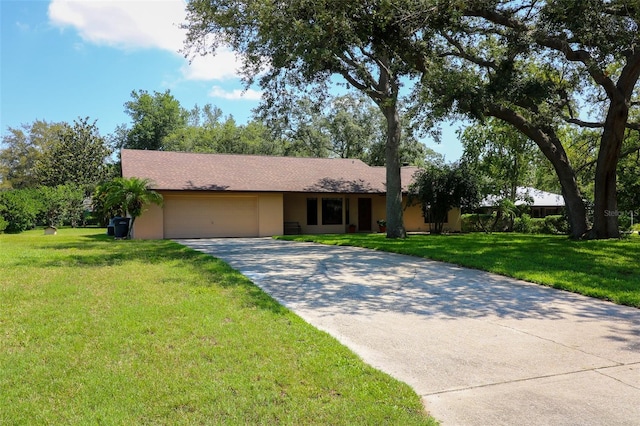 3567 Red Oak Ct, Lake Wales, FL 33898 - ranch-style house with a garage, concrete driveway, a front lawn, and stucco siding