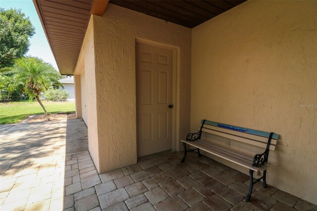 3567 Red Oak Ct, Lake Wales, FL 33898 - doorway to property with stucco siding and a patio