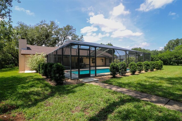 3567 Red Oak Ct, Lake Wales, FL 33898 - rear view of property with a yard, an outdoor pool, and a chimney