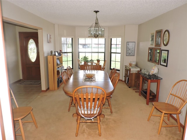 3567 Red Oak Ct, Lake Wales, FL 33898 - dining space featuring a chandelier, light carpet, and a textured ceiling