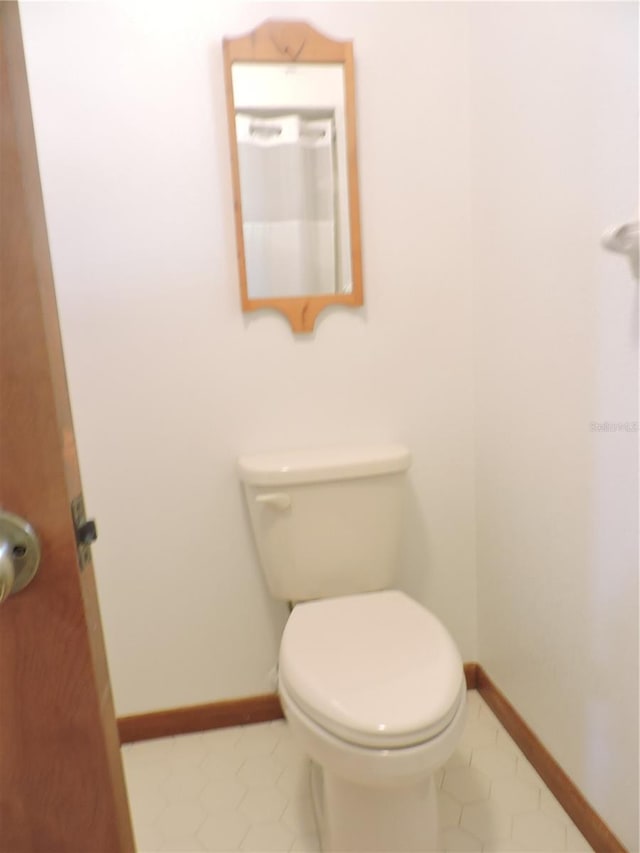 3567 Red Oak Ct, Lake Wales, FL 33898 - bathroom featuring baseboards, toilet, and tile patterned flooring