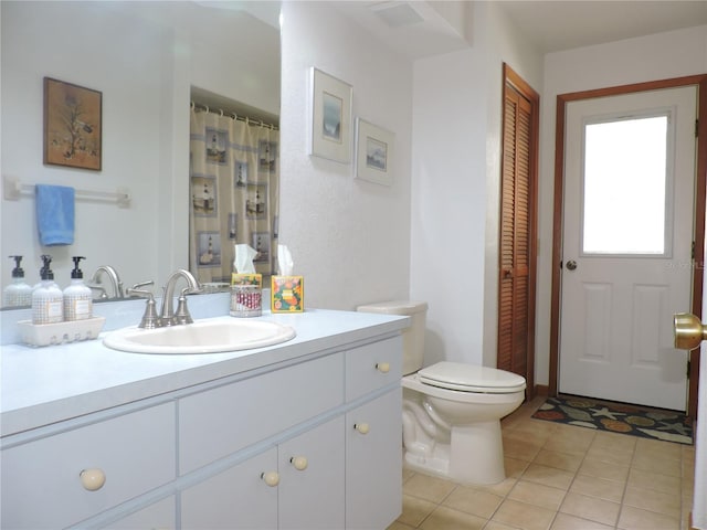 3567 Red Oak Ct, Lake Wales, FL 33898 - bathroom featuring vanity, toilet, tile patterned floors, and a closet