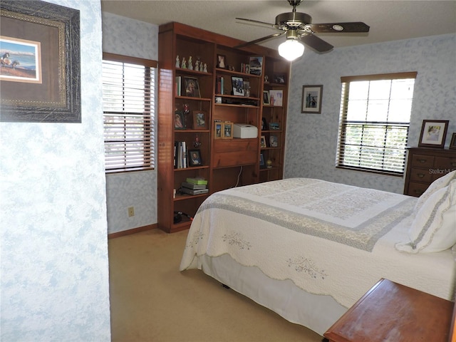 3567 Red Oak Ct, Lake Wales, FL 33898 - bedroom with wallpapered walls, light carpet, and ceiling fan