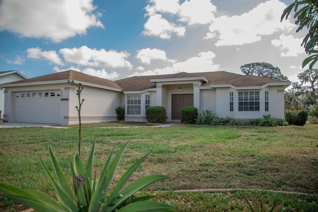 view of front of home featuring a front yard, an attached garage, driveway, and stucco siding