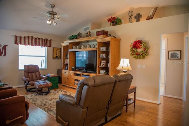 living room featuring a ceiling fan, vaulted ceiling, visible vents, light wood finished floors, and baseboards