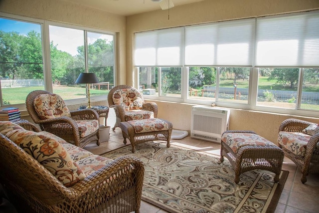 sunroom / solarium featuring tile patterned floors and a textured wall
