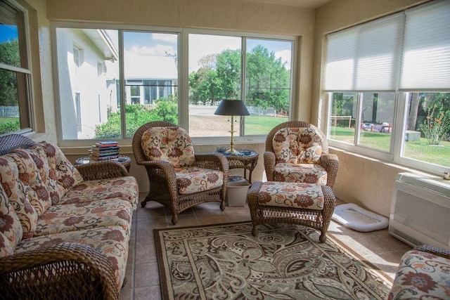 sunroom / solarium featuring an outdoor living space, heating unit, and tile patterned flooring