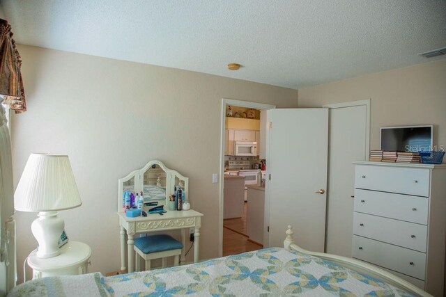 bedroom featuring a textured ceiling and visible vents