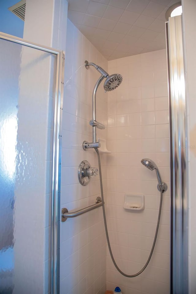 bathroom featuring visible vents and a stall shower