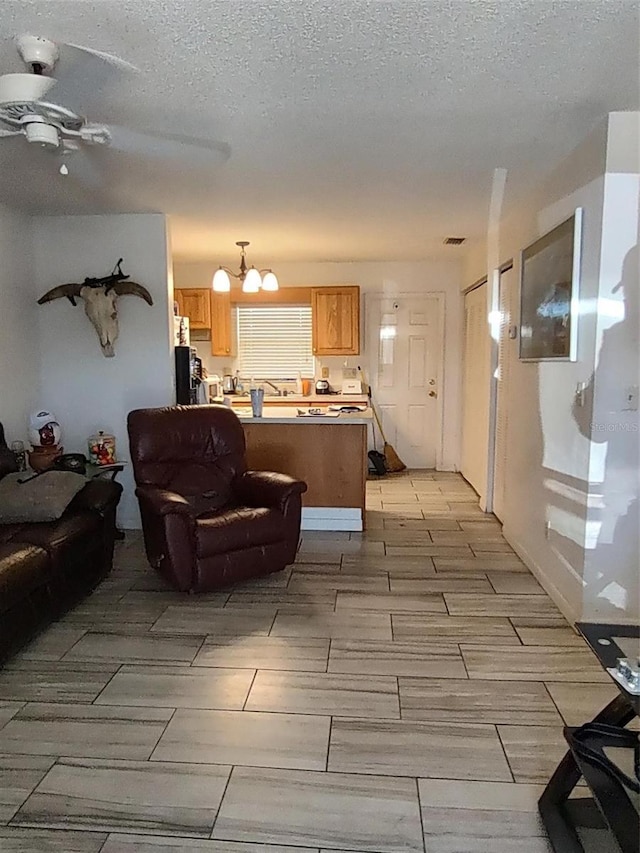 1402 Thousand Roses Dr W Unit 1402, Lake Wales, FL 33853 - living area featuring a chandelier and a textured ceiling
