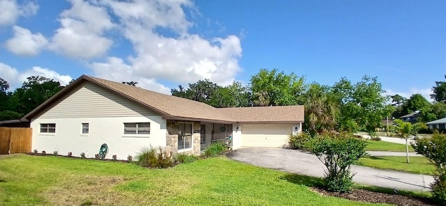 ranch-style home with a garage, a front lawn, and concrete driveway
