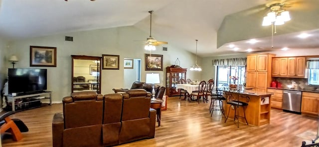 living room featuring visible vents, a ceiling fan, wood finished floors, and high vaulted ceiling