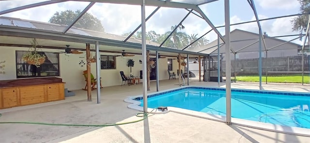 outdoor pool featuring a patio area, glass enclosure, fence, a hot tub, and ceiling fan