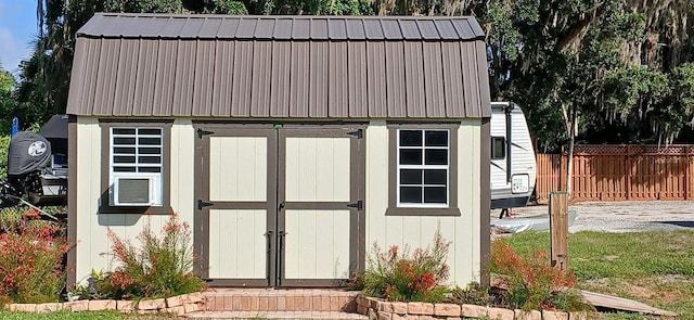 view of shed featuring fence