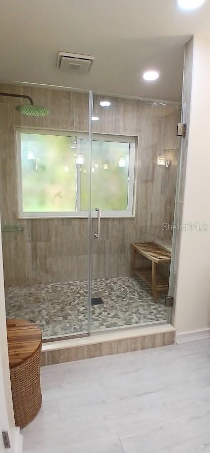 bathroom featuring recessed lighting, a shower stall, visible vents, and baseboards