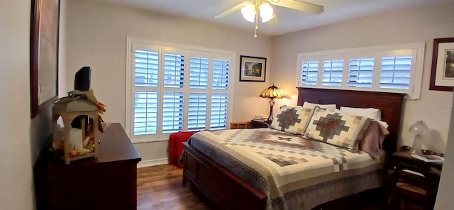 bedroom with baseboards, wood finished floors, ceiling fan, and multiple windows