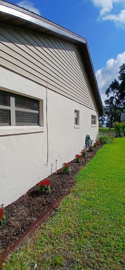 view of home's exterior featuring a lawn and stucco siding
