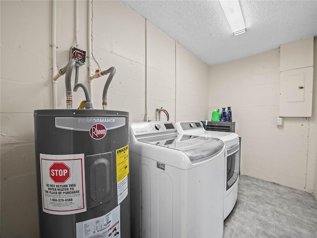 clothes washing area with laundry area, a textured ceiling, electric panel, separate washer and dryer, and water heater