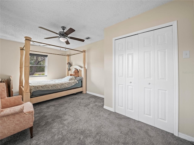 bedroom with carpet flooring, a textured ceiling, baseboards, and a closet