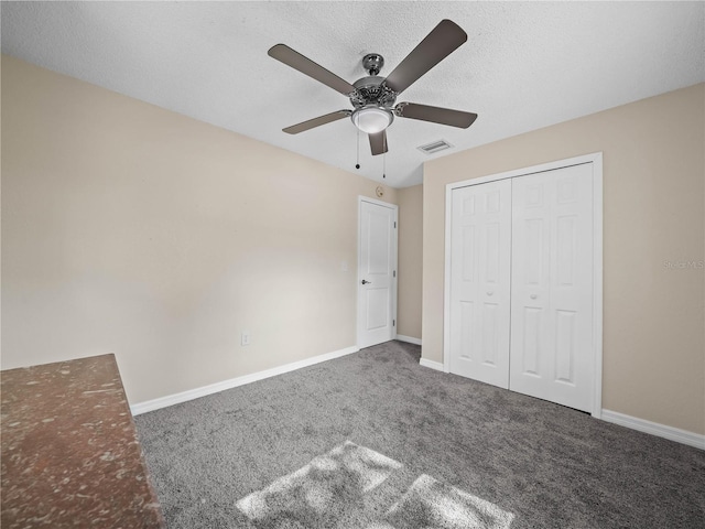 unfurnished bedroom featuring baseboards, carpet flooring, and visible vents