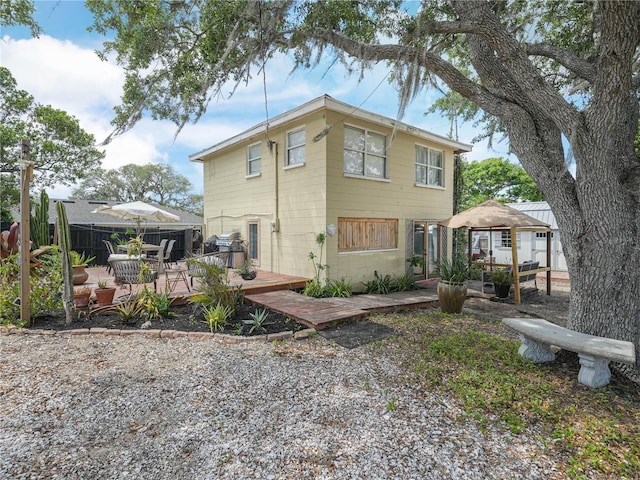 1351 Smokey Rd, Lake Wales, FL 33859 - rear view of house featuring a gazebo, a wooden deck, and fence
