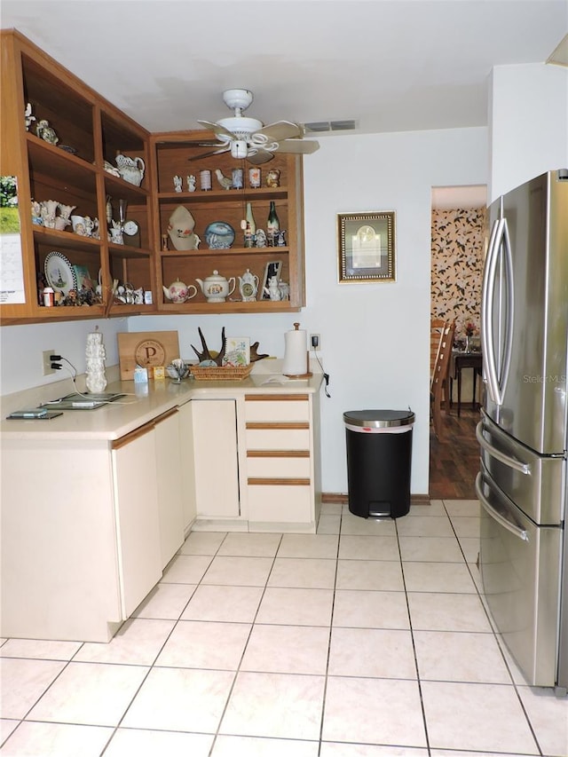 kitchen featuring open shelves, ceiling fan, light countertops, freestanding refrigerator, and visible vents