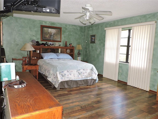 bedroom with a textured ceiling, ceiling fan, and wood finished floors