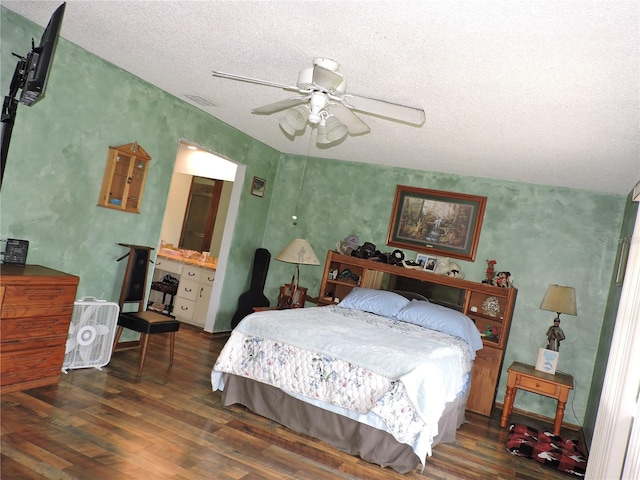 bedroom with a textured ceiling, ceiling fan, and wood finished floors