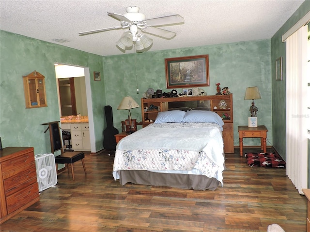 bedroom featuring visible vents, a textured ceiling, and wood finished floors