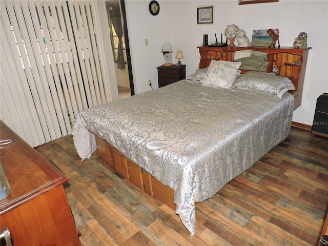 bedroom with dark wood-style floors