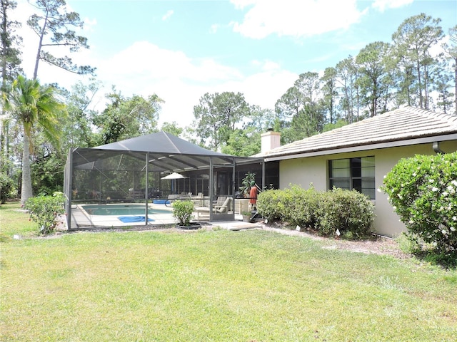 back of property featuring an outdoor pool, stucco siding, a chimney, a lawn, and glass enclosure